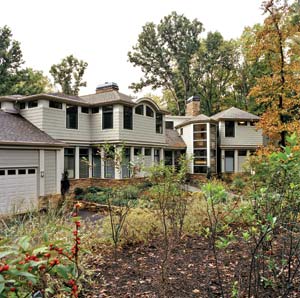 The homeowners hired an arborist to inventory existing species, relocate large trees, install root-aeration mats and put up tree fencing. After the house was finished, regrading approximated the land's natural contours. A terraced rain garden slows runoff from the driveway.